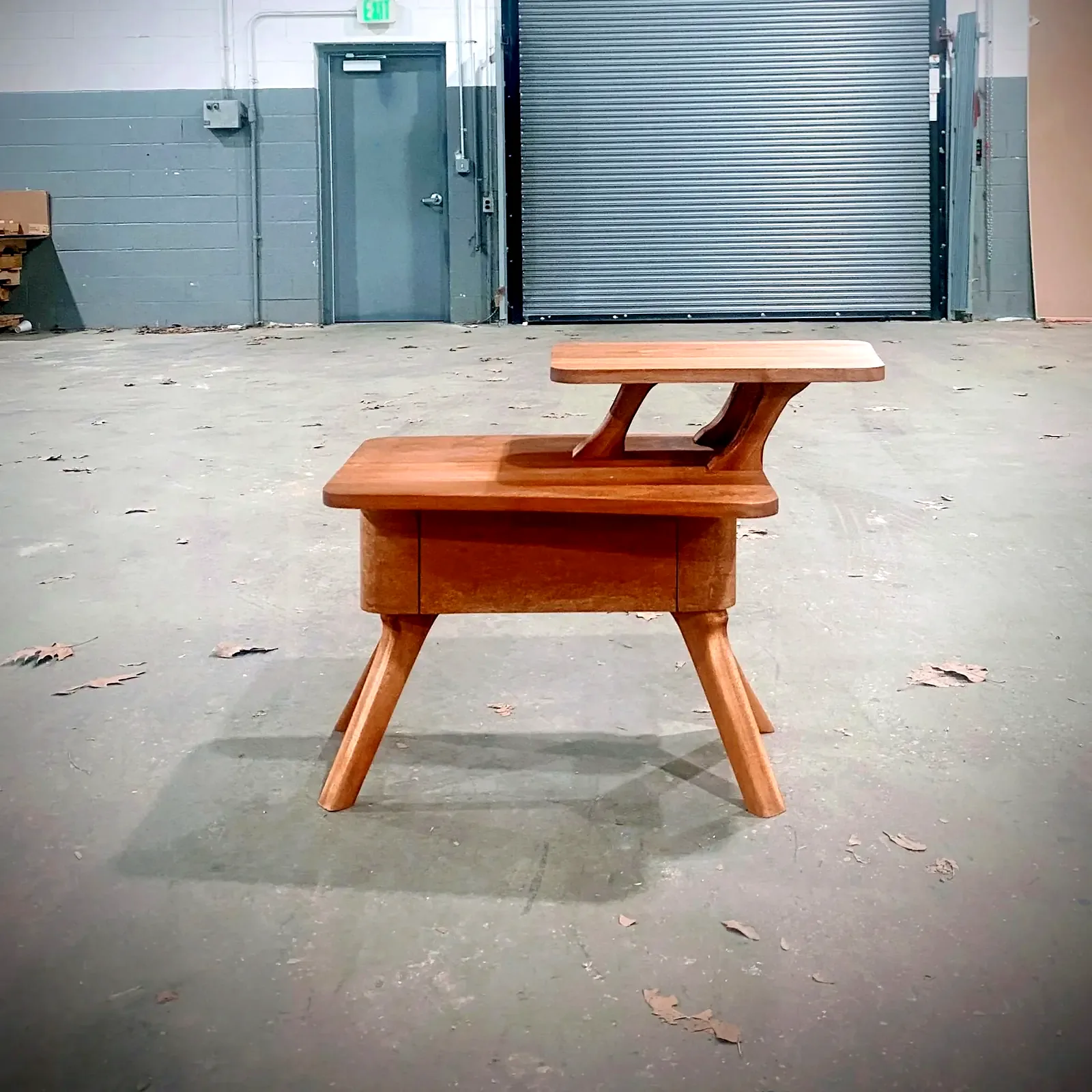 Sculpted hardwood school desk on splayed legs